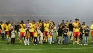 Lens players and their families greet the fans at the end of the French L1 football match between RC Lens and FC Nantes after qualifying for the Champions League. (Photo by Francois LO PRESTI / AFP)