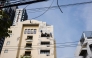 Workers repair the exterior of a building in Bangkok on May 8, 2026. (Photo by ANTHONY WALLACE / AFP)