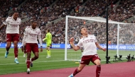 Arsenal's Belgian midfielder Leandro Trossard celebrates scoring the team's first goal during the English Premier League football match between West Ham United and Arsenal at the London Stadium, in east London on May 10, 2026. (Photo by Adrian Dennis / AFP) /