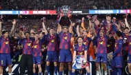 Barcelona's team celebrates winning the 2025-2026 Spanish League after the Spanish league football match between FC Barcelona and Real Madrid CF at Camp Nou Stadium in Barcelona on May 10, 2026. (Photo by Josep LAGO / AFP)