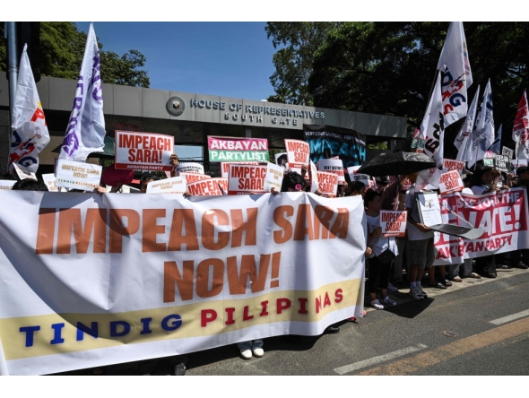Protesters holding banners protest in support of the impeachment of Philippine Vice-President Sara Duterte in front of the House of Representatives in Quezon City, Metro Manila  (Photo by Ted  Aljibe / AFP)