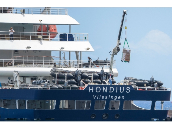 The Dutch flagged hantavirus-stricken cruise ship MV Hondius receives provisions from a boat in the port of Granadilla de Abona on the island of Tenerife in Spain's Canary Islands on May 11, 2026. Photo by JORGE GUERRERO / AFP