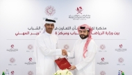 Assistant Undersecretary for Youth Affairs at the Ministry of Sports and Youth, Ahmed Mohammed Al-Harami and Executive Director of QCDC, Saad Abdulla Al-Kharji (left) at the MoU signing.