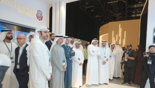 Officials touring exhibitors on the opening day of the summit yesterday. 