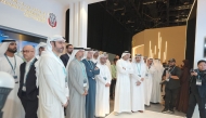 Officials touring exhibitors on the opening day of the summit yesterday. 