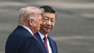 China's President Xi Jinping (R) looks at US President Donald Trump during a welcome ceremony at the Great Hall of the People in Beijing on May 14, 2026. (Photo by Brendan Smialowski / AFP)
