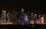 Illuminated skyscrapers are pictured along the corniche promenade in Doha on May 15, 2026. (Photo by Karim JAAFAR / AFP)
