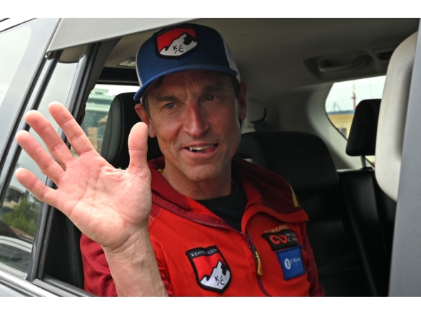 British climber Kenton Cool waves from a car upon his arrival at the airport in Kathmandu. (Photo by Prakash Mathema / AFP)