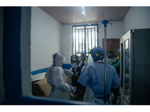 Dr Abdou Sebushishe (2nd L) Senior Health Advisor at International Medical Corps, guides and shows CBCA Virunga doctors how to properly put on single-use personal protective equipment provided by International Medical Corps, as part of support for Ebola virus disease prevention measures in Goma, on May 21, 2026. (Photo by Jospin Mwisha / AFP)