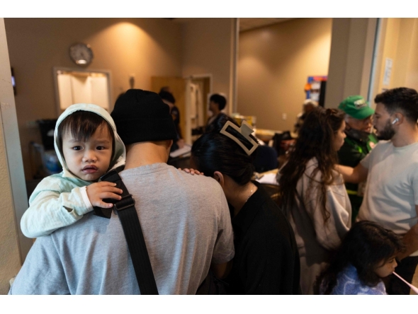 Evacuees check-in at a shelter after a chemical leak from a large storage tank threatened residents in Garden Grove, California on May 22, 2026. (Photo by Blake Fagan / AFP)