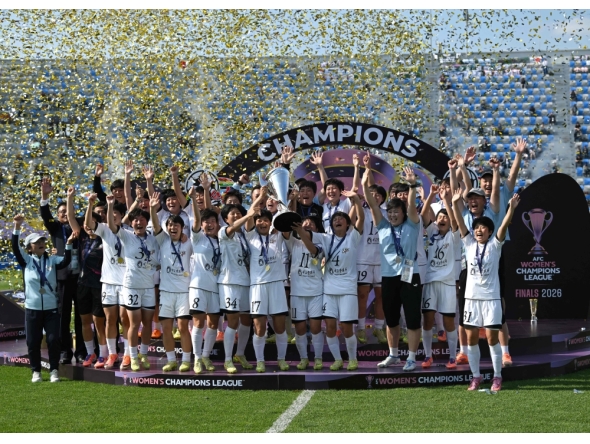 Naegohyang Women's FC players celebrate with the trophy during the victory ceremony after the AFC Women's Champions League final football match between North Korea's Naegohyang Women's FC and Japan's Tokyo Verdy Beleza in Suwon on May 23, 2026. (Photo by Jung Yeon-je / AFP)