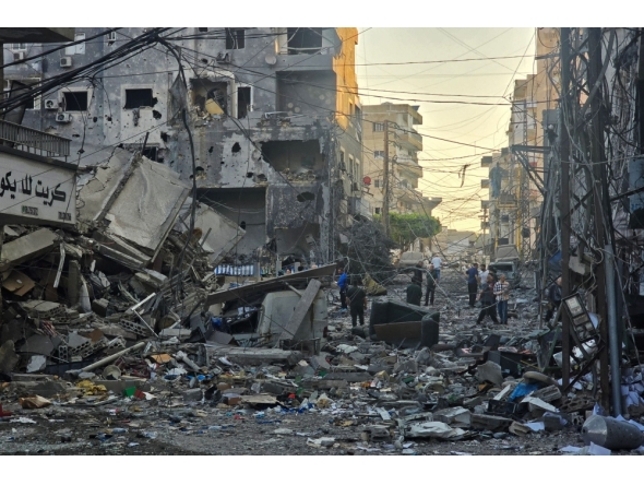 People inspect the site of an Israeli strike in the southern Lebanese coastal city of Tyre on May 23, 2026. (Photo by Kawnat Haju/ AFP)