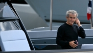 :(FILES) French former driver Alain Prost arrives by boat in the paddock of the Circuit de Monaco before the third practice session of the Formula One Monaco Grand Prix on May 25 2024, on the eve of the race. (Photo by NICOLAS TUCAT / AFP)