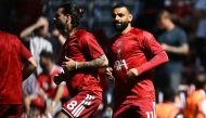 Liverpool's Hungarian midfielder #08 Dominik Szoboszlai (L) and Liverpool's Egyptian striker #11 Mohamed Salah (R) warm up ahead of the English Premier League football match between Liverpool and Brentford at Anfield in Liverpool, north west England on May 24, 2026. (Photo by Paul ELLIS / AFP)