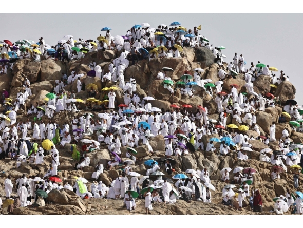 Muslim pilgrims pray on  Mount Arafat, also known as Jabal al-Rahma or Mount of Mercy, in Makkah, Saudi Arabia, on May 26, 2026. (Photo by Zain JAAFAR / AFP)