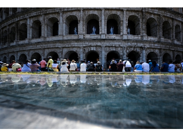 People sit in the shade of the Colosseum during an early-season heatwave in Rome on May 28, 2026. Photo by TIZIANA FABI / AFP