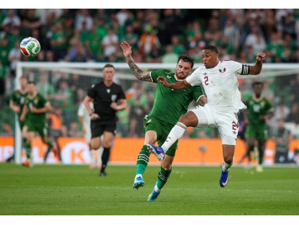 Ireland’s Troy Parrott (left) battles for the ball with Qatar’s Pedro Miguel. (AFP)