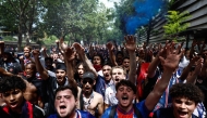 PSG supporters chant slogans ahead of the UEFA Champions League Final football match between Paris Saint-Germain (PSG) and Arsenal FC played in Budapest, next to the Parc des Princes stadium, in Paris on May 30, 2026. (Photo by Kenzo Tribouillard / AFP)