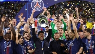Paris Saint Germain's president Nasser al-Khelaifi (C) lifts the trophy as he celebrates with his players winning the UEFA Champions League final football match between Paris Saint-Germain (PSG) and Arsenal FC at the Puskas Arena in Budapest on May 30, 2026. (Photo by FRANCK FIFE / AFP)