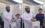 A child receives an Eid gift during the programme.  