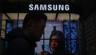 A man walks past a Samsung store in Seoul on May 28, 2026. (Photo by Pedro Pardo / AFP)
