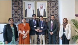 The winning team with the school officials.