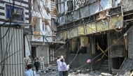 Forensics team members take photographs of the site following a fire that broke out at a hotel in New Delhi on June 3, 2026. (Photo by Arun Sankar / AFP)