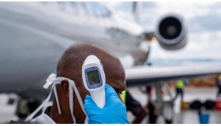 A passenger's temperature is checked at Bunia Airport in eastern Democratic Republic of the Congo on June 3, 2026. Photo by GLODY MURHABAZI / AFP