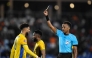 Gabon's forward #20 Denis Bouanga is shown the yellow card by Somali referee Omar Abdulkadir Artan during the Africa Cup of Nations (CAN) Group F football match between Gabon and Ivory Coast at the Grand Stadium in Marrakech on December 31, 2025. Photo by KHALED DESOUKI / AFP