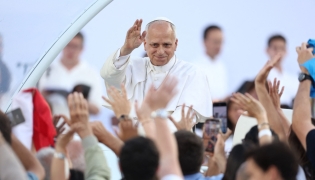 Pope Leo XIV greets the crowd as he arrives to attend a prayer vigil at the Lluis Companys Olympic Stadium in Barcelona, on June 9, 2026. (Photo by Josep Lago / AFP)