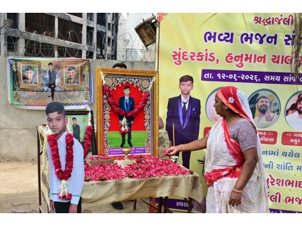 A family member of Air India plane crash victim Akash Patni pays tribute at the crash site on the first anniversary of the disaster in Ahmedabad on June 12, 2026. (Photo by Shammi Mehra / AFP)
