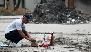 A tribute is set up for Air India Flight 171 plane crash victim Vijay Rupani, former Gujarat chief minister, at the crash site on the first anniversary of the disaster in Ahmedabad on June 12, 2026. Photo by Shammi MEHRA / AFP