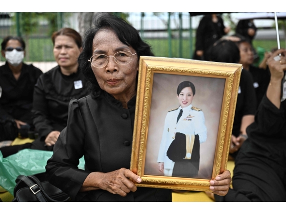 A mourner holds a portrait of late Thai Princess Bajrakitiyabha Mahidol outside the Grand Palace in Bangkok on June 13, 2026. (Photo by Lillian Suwanrumpha / AFP)