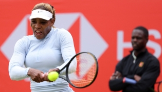 US player Serena Williams hits a shot during a practice session, watched US coach Jarmere Jenkins, at the HSBC WTA tennis Championships at Queen's Club in west London on June 12, 2026.  (Photo by Adrian Dennis / AFP)