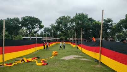 People look at a 7.5 kilometres (4.7 miles) long national flag of Germany commisioned by their football team fan Bangladeshi farmer Amjad Hossain, upon its display across a field in Magura district on June 10, 2026, on the eve of the 2026 FIFA World Cup tournament. Photo by AFP