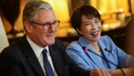 Britain's Prime Minister Keir Starmer (L) and Japan's Prime Minister Sanae Takaichi attend a business roundtable meeting at Downing Street in central London (Photo by Toby Shepheard / POOL / AFP)