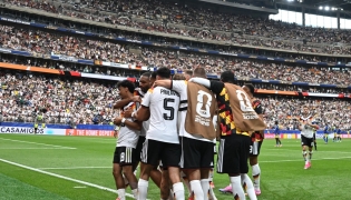 Germany's defender #18 Nathaniel Brown (C) celebrates with teammates after scoring his team's fifth goal during the 2026 World Cup Group E football match between Germany and Curacao at the Houston Stadium in Houston on June 14, 2026.
(Photo by RONALDO SCHEMIDT / AFP)