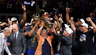 New York Knicks owner James Dolan lifts the Larry O'Brien Championship Trophy after his team defeated the San Antonio Spurs in Game Five of the 2026 NBA Finals at Frost Bank Center on June 13, 2026 in San Antonio, Texas. Gregory Shamus/Getty Images/AFP (Photo by Gregory Shamus / GETTY IMAGES NORTH AMERICA / Getty Images via AFP)