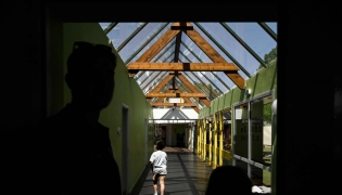 (Files) A child walks along the glass-roofed corridor of the Isle Verte primary school on May 28, 2026. (Photo by Philippe Lopez / AFP)