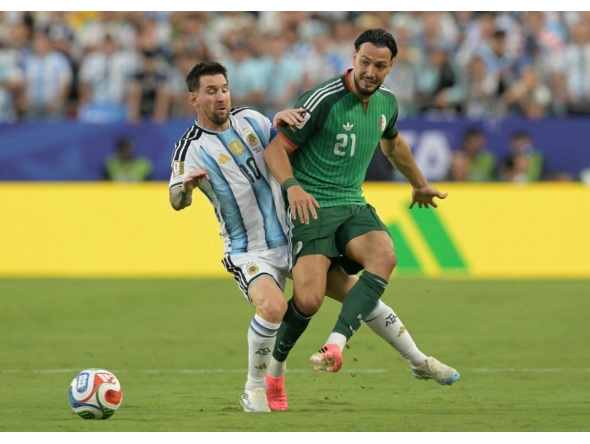 Argentina's forward #10 Lionel Messi and Algeria's defender #21 Ramy Bensebaini during the 2026 World Cup Group J football match between Argentina and Algeria at the Kansas City Stadium in Kansas City on June 16, 2026. (Photo by JUAN MABROMATA / AFP)