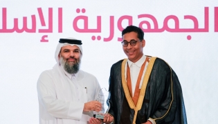 Undersecretary of the Ministry of Awqaf and Islamic Affairs H E Dr. Sheikh Khalid bin Mohammed bin Ghanem Al Thani honouring a graduate at the ceremony.