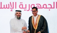 Undersecretary of the Ministry of Awqaf and Islamic Affairs H E Dr. Sheikh Khalid bin Mohammed bin Ghanem Al Thani honouring a graduate at the ceremony.