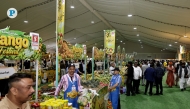 Stalls in Souq Waqif displaying fresh mangoes and other related products from India.