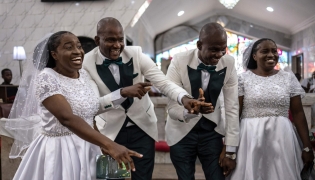 Grooms and brides dance during their wedding ceremony at the Bishop Akinyele Memorial Anglican Church in Ibadan, on June 20, 2026. (Photo by OLYMPIA DE MAISMONT / AFP)