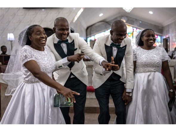 Grooms and brides dance during their wedding ceremony at the Bishop Akinyele Memorial Anglican Church in Ibadan, on June 20, 2026. (Photo by OLYMPIA DE MAISMONT / AFP)