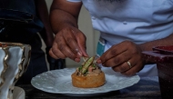 Congolese chef Archi Dimosi plates one of his signature dishes in Kinshasa on May 17, 2026. (Photo by Hardy Bope / AFP)