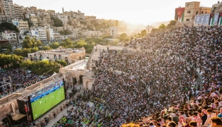 Jordanian football fans gather to watch on giant screens their national team's 2026 World Cup Group J football match against Algeria at Amman's 2nd-century Roman amphitheatre early on June 23, 2026. (Photo by George SAIF / AFP)