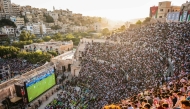 Jordanian football fans gather to watch on giant screens their national team's 2026 World Cup Group J football match against Algeria at Amman's 2nd-century Roman amphitheatre early on June 23, 2026. (Photo by George SAIF / AFP)