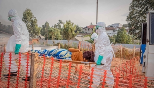 Healthcare workers carry on a stretcher a patient suffering from the Ebola virus disease from an ambulance at the Ebola Treatment Center (ETC) in Bunia, Ituri, in the east of the Democratic Republic of Congo on June 23, 2026. (Photo by Benediction MURHABAZI / AFP)