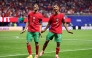 Gessime Yassine #16 of Morocco celebrates with teammate Achraf Hakimi #2 after scoring his team's fourth goal on June 24, 2026 in Atlanta, Georgia. Kevin C. Cox/Getty Images/AFP
